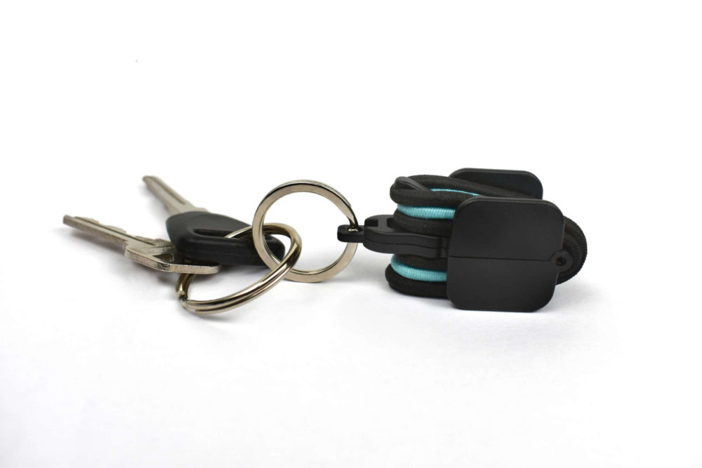 Black hair tie holder on keys