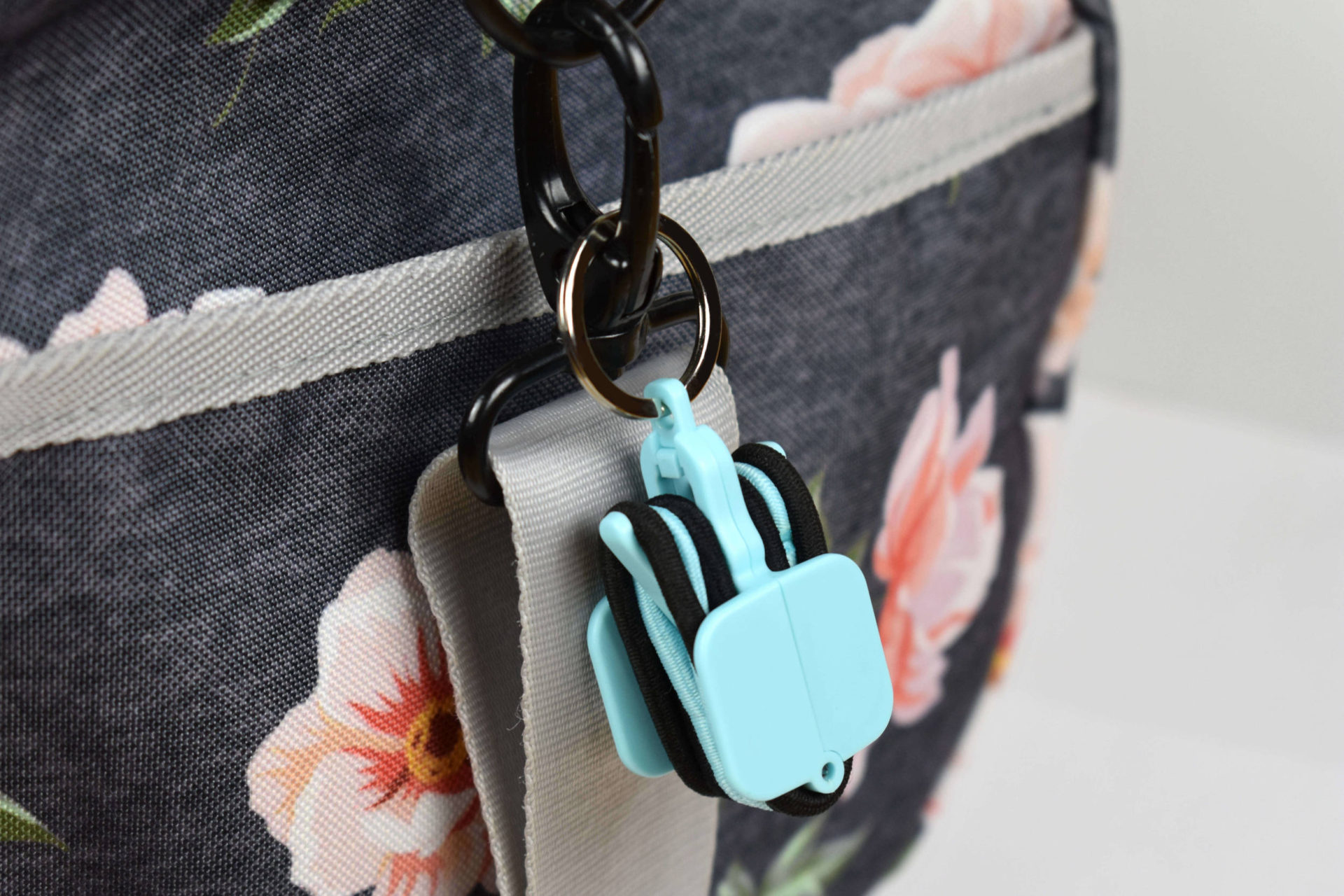 Light blue hair tie holder on bag